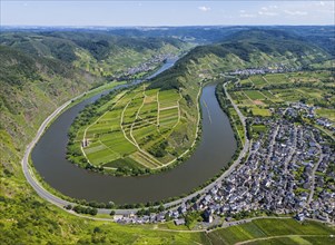 A river bend cuts through a hilly landscape with vineyards and a neighbouring village, surrounded