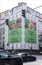 Large advertising banner, façade cladding, during construction work, advertising the food delivery