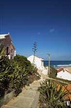 Colourful holiday homes and beach, Monte Clérigo, Atlantic coast, Algarve, Portugal, Europe