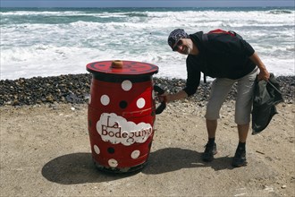 Red outdoor bar table, hiker, tourist holding jug, bar, beach bar, Cabo de Gata Natural Park,