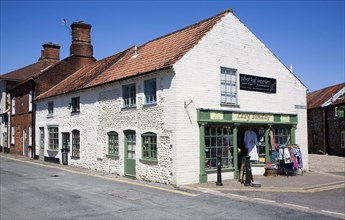 Shops in historic buildings in the town of Holt, north Norfolk, England, United Kingdom, Europe