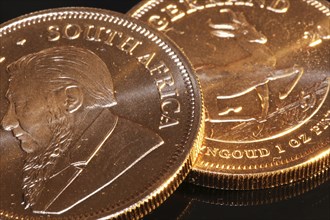 Close-up of two Krugerrand gold coins