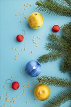 Christmas or New Year composition. Decorations, blue, red, yellow balls, fir and spruce branches,