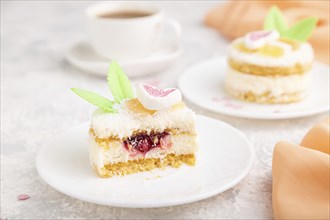 Decorated cake with milk and coconut cream with cup of coffee on a gray concrete background and