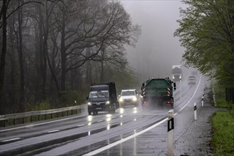 Traffic on a country road in the rain, B229, spring, near Radevormwalde, Oberbergischer Kreis,