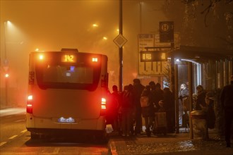 Bus stop, in the fog, passengers boarding a bus, autumn, winter, Essen, North Rhine-Westphalia,