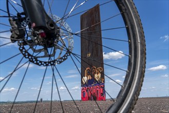 Cycling in the Ruhr area, on the Schurenbach slag heap, Bramme landmark for the Ruhr area by artist