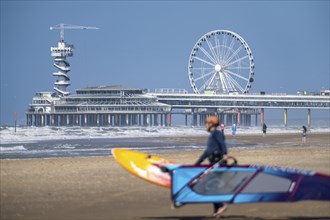 The pier and Ferris wheel at Scheveningen beach, strong swell, windsurfers, Netherlands