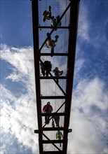 Lattice walkway, people walk over a walkway at a height of a good 15 metres, made of steel lattice,