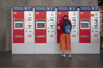 Railway customer buys a ticket at the ticket machine, Würzburg, Lower Franconia, Bavaria, Germany,