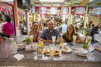 Tourists sitting at a table at a food stall, Mercado Central de San José, San José, Costa Rica,