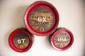 Wall mounted Wadworth brewery decorative old barrels, George and Dragon Inn, Potterne, Wiltshire,