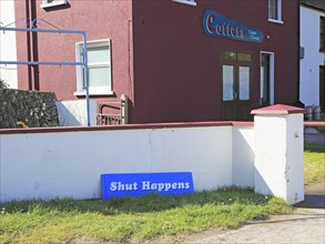 'Shut Happens' funny sign for closed Cotters bar pub, Cape Clear Island, County Cork, Ireland,