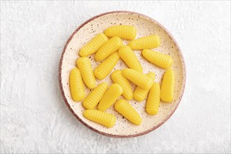 Jelly corn candies on gray concrete background. top view, flat lay, close up