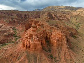 Eroded mountain landscape, canyon with red and orange rock formations, aerial view, Konorchek