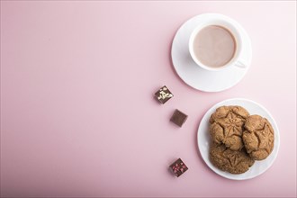 Homemade oatmeal cookies with a cup of cocoa on a pink pastel background. top view, flat lay, copy