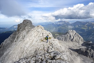 Mountaineer on a narrow rocky ridge, Watzmann crossing to Watzmann Mittelspitze, view of mountain