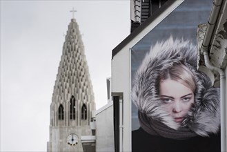 Advertisement on house wall, Hallgrimskirkja or church of Hallgrímur, landmark of Reykjavík,