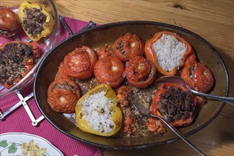 Stuffed tomatoes and peppers with rice and minced meat in a casserole on the table, Bavaria,