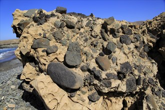 Conglomerate rock with volcanic bombs embedded in sediment, Playa de Garcey, Fuerteventura, Canary