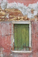 Closed window shutter on a residential building in Burano, Veneto, Italy, Europe