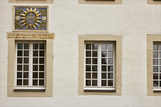 White windows a colourful family coat of arms on a house in Warendorf, Warendorf district, North