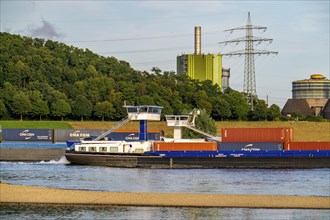 Industrial backdrop of the ThyssenKrupp Steel steelworks in Bruckhausen, on the Rhine, cargo ship,