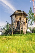 Small wooden hut under a blue sky on a playground, Nagold, Black Forest, Germany, Europe