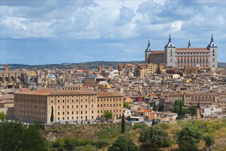 Toledo city view with historic buildings and a cathedral under a blue sky with clouds, Seminario