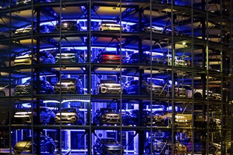 An illuminated car tower with new cars for delivery in the evening, detail, Autostadt, Volkswagen