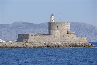 Agios Nikolaos fortress with lighthouse, Mandraki harbour, Rhodes town, Rhodes, Greece, Europe