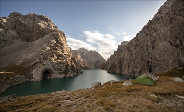 Wild camping, camping in the wilderness with a tent in front of mountain lake Kol Suu, Sary Beles