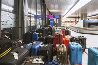 Many lost suitcases and pieces of luggage are ready for collection at an airport