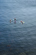 People on paddleboards, White Cliffs. Old Harry Rocks Jurassic Coast, Dorset Coast, Poole, England,