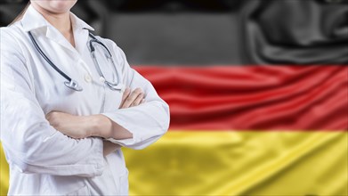 Female doctor with arms crossed with German flag in the background. Healthcare concept with Germany