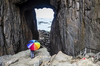 Woman with colorful umbrella, Torghatten cave, Torghatten mountain, Brønnøysund, Norway, Europe