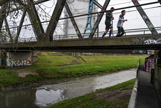 The River Emscher, sewage river, old railway bridge, now a footpath and cycle path, bridge for