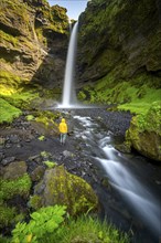 Tourist at Kvernufoss waterfall, in summer when the weather is nice, gorge and river, long