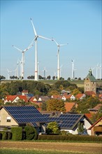 Wind farm above the village of Lichtenau, self-proclaimed energy town, houses with photovoltaic