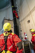 Height rescuers from the Oberhausen professional fire brigade practise abseiling from a wind