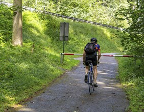 Cyclist on a circular route on Lake Tegernsee, Bavaria, Germany, Europe