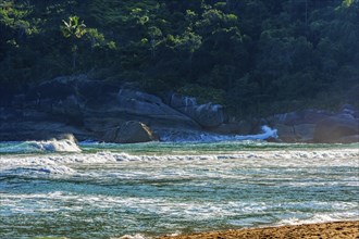 The sea and the waves in front of the rocks of Bonete beach on the island of Ilhabela, Bonete