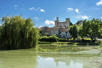 Billy. The fortified castle dating back to the 13th century, overlooks a pond, Allier,