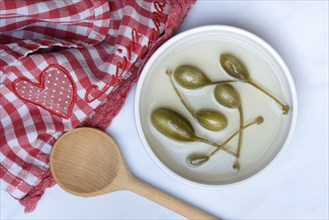 Caper apples in skin and cooking spoon, caper, caper fruit, Capparis spinosa