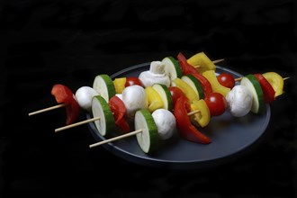 Colourful vegetable skewers on a plate, barbecue skewers