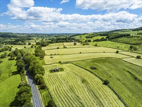 Farms and Fields over Bainbridge Village from a drone, Leyburn, North Yorkshire, England, United