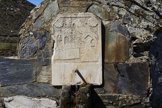 Engraved stone tablet with religious symbols, set into a rock, Chapel of Agios Ioannis Prodromos,