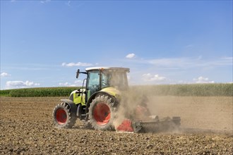 Symbolic image, global warming, dry soil, dust, farmer tilling a field, tractor, ploughing, clouds,