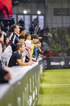 Football players sit on the bench and watch the game, Mercedes Benz Junior Cup, Glaspalast