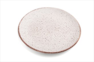 Empty pink dotted ceramic plate isolated on white background. Side view, close up